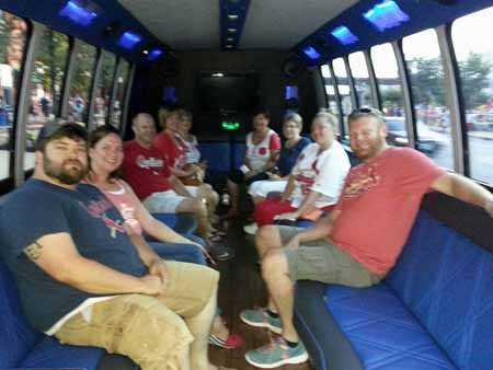 Cardinal fans take luxury shuttle bus to game.