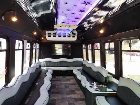 Rental party bus has colored lights inside.